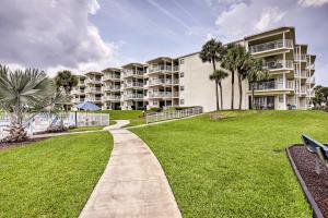 una pasarela frente a un gran edificio de apartamentos en St Augustine Beach Condo with Patio and Pool Access!, en Butler Beach