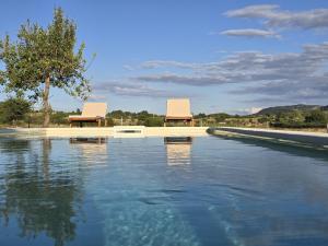 two chairs sitting on top of a pool of water at Villa Vucipolje in Posušje