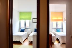 a room with three beds and a window at Casa Mareta in Sagres