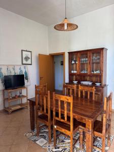 a dining room with a wooden table and chairs at Vista Mare in Marettimo