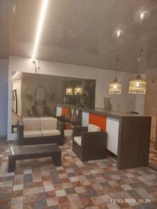 a living room with couches and a table and a kitchen at San Francisco Plaza Real in Bucaramanga