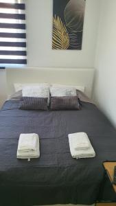 a bedroom with a bed with two towels on it at Kop Čardaci apartman Petković in Kopaonik +15 photos