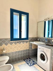 a bathroom with a washing machine and a sink at Vista Mare in Marettimo +5 photos