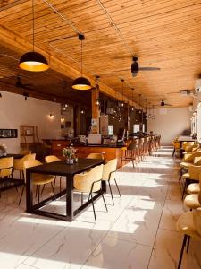 a dining room with tables and chairs and wooden ceilings at The Hotel Pendleton, Trademark Collection by Wyndham in Pendleton