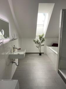 a bathroom with a sink and a toilet and a window at Hengstresort Velten in Velten
