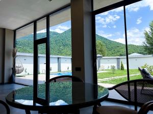 a room with a table and chairs and a window at Qafqaz Golden Loft in Gabala