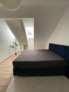 a bedroom with a bed in a white room at Hengstresort Velten in Velten