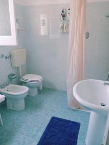 a bathroom with two toilets and a sink and a shower at Casa al tramonto...sunset lovers retreat in Lipari