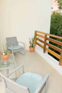 a balcony with chairs and a table and a fence at Oasis del Sol in Playa del Carmen