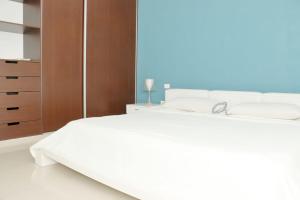 a bedroom with two white beds and a wooden cabinet at Oasis del Sol in Playa del Carmen +4 photos