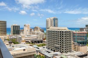 a view of a city with tall buildings and the ocean at Renovated Condo Near Waikiki Beach in Honolulu