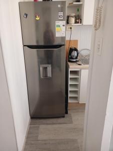 a stainless steel refrigerator in a kitchen at 306 pucara in Ovalle