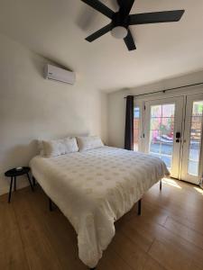 a bedroom with a large bed with a ceiling fan at Events Allowed: Sunny Villa| Lake| Trails| Beach in La Mesa +57 photos