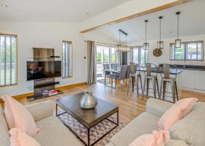 a living room with a couch and a table at Cherry Bird Country Park in Newbury