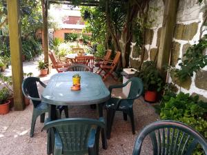 a blue table with chairs and a drink on it at Metro Casa Música Apartments and Rooms in Porto