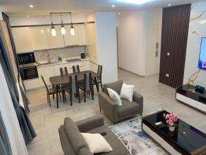 a living room with a table and a dining room at Nova luxe 2 Bed Executive Stay in Accra