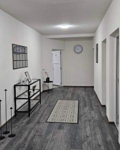 an empty room with a clock on the wall at Apartments Una Roots in Orašac