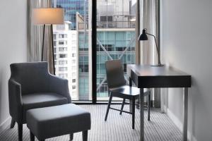 a desk and chair in a room with a window at Four Points by Sheraton Brisbane in Brisbane +35 photos