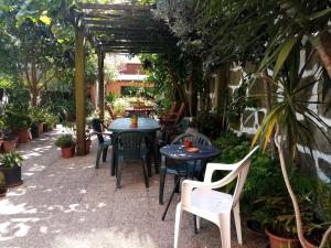 a patio with tables and chairs in a garden at Metro Casa Música Apartments and Rooms in Porto +73 photos