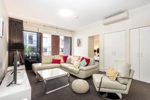 a living room with a couch and a table at Subiaco Rooftop on Sheen in Perth