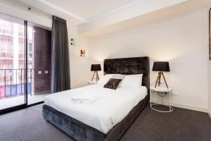 a bedroom with a large bed and a large window at Subiaco Rooftop on Sheen in Perth