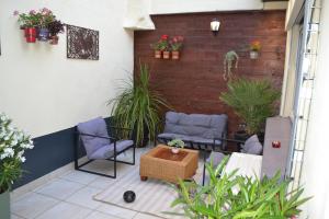 a patio with two chairs and a table at La Vie Est Belle in Dunkerque