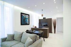 a living room with a couch and a table at Mama suites Politeama in Palermo