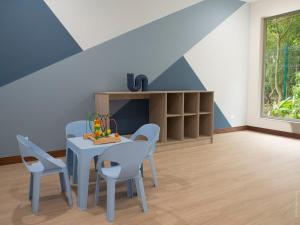 a dining room with a blue table and chairs at Casa Mar Jaco Selva Coral in Jacó