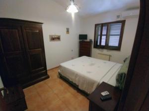 a bedroom with a bed and a wooden cabinet at Villa Sonia in Maddalenedda +65 photos