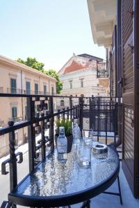 a table on a balcony with a view of a street at Mama suites Politeama in Palermo