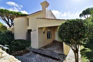 a house with a cross on the top of it at Villa Quadradinhos 21Q 4 Bedroooms Private Pool Vale Do Lobo in Vale do Lobo