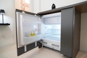 an empty refrigerator with its door open in a kitchen at Mama suites Politeama in Palermo
