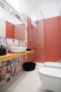 a bathroom with a white toilet and a sink at Mama suites Politeama in Palermo +44 photos