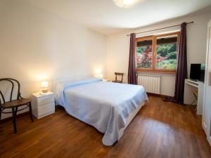 a bedroom with a bed and a window at House Piccola California Sea View in Muggia
