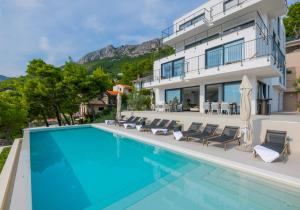 an image of a villa with a swimming pool at Beautiful Seafront Split Villa 9 Bedrooms Bellamar Vista Retreat Large Heated Infinity Pool & Jacuzzi Makarska in Makarska