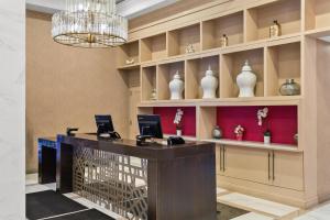 a lobby with a reception desk and a chandelier at Sonesta Hotel Baltimore Inner Harbor in Baltimore