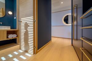 a bathroom with blue walls and a door with a mirror at Immensely Luxurious Hvar Villa 5 Bedrooms Villa East Eternal Exceptional Sea Views & Private Pool in Hvar