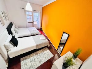 a small room with two beds and a mirror at Amazing rooms in centre of Lisbon, best location in Lisbon