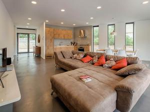 un grand salon avec un grand canapé marron dans l'établissement Frontline Korcula Villa A Stones Throw To The Beach Villa Korcula Bay View, à Korčula