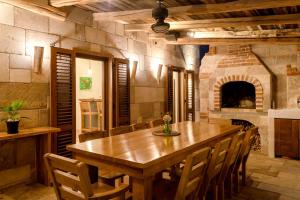 a large dining room with a wooden table and chairs at Astounding Hvar Villa 4 Bedrooms Villa Crystal Hvar 1 Mesmerizing Sea Views & Private Infinity Pool in Hvar