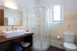 a bathroom with a shower and a sink and a toilet at Luxurious Agios Georgios Villa Private Pool Villa Spyridoula Beach Paradise in Agios Georgios +21 photos