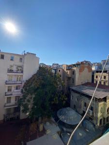 a view of a city with a tree and buildings at Taksim Sofa House in Istanbul