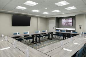 a conference room with tables and chairs and a screen at Residence Inn by Marriott Indianapolis Noblesville in Noblesville +17 photos
