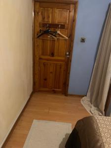 a bathroom with a wooden door with a sink in it at Sweet home in Moffat