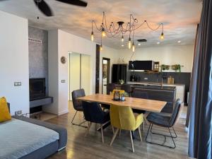 a dining room and living room with a table and chairs at Holiday&Suite Klanac in Vir