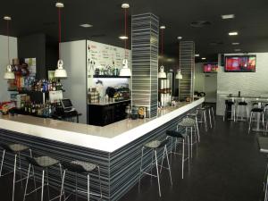 a bar in a restaurant with stools at Pensión Teyma in Ponteceso