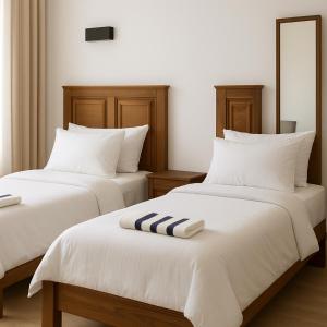 Postel nebo postele na pokoji v ubytování Swiss Bay Hotel & Resort-Arugambay