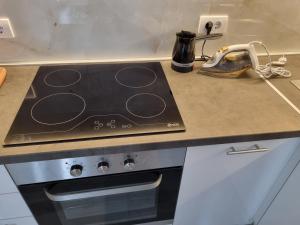 a stove top oven sitting on a kitchen counter at Stan na dan Bor in Bor +14 photos