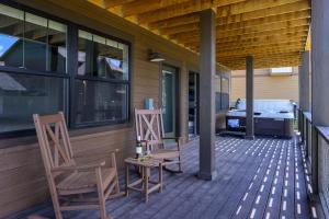 two chairs and a grill on the porch of a house at Aspen View Chalet home in Fraser