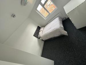a room with a bed with a window in it at Gedling house in Nottingham